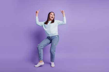 Photo of positive funky lady dance festive mood vibes wear blue shirt isolated on purple backgroundの写真素材