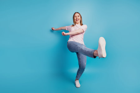 Photo of funny crazy tourist lady walk enjoy stroll wear white t-shirt isolated on blue background
