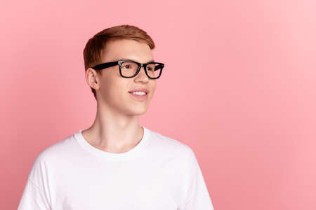 Profile side photo of young man eyewear look empty space thoughtful isolated over pink color backgroundの写真素材