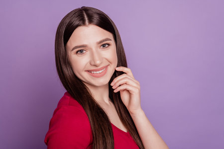 Portrait of happy joyful dreamy adorable woman look camera shiny smile on purple backgroundの写真素材