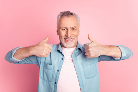 Photo of mature man show fingers thumbs-up perfect ads promotion isolated over pink color background