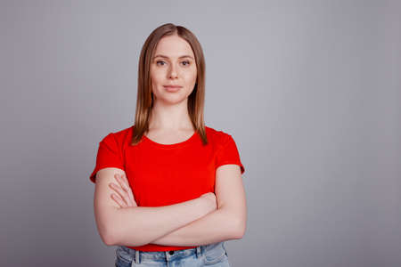 Photo of young pretty girl confident crossed hands career freelancer isolated over grey color backgroundの写真素材