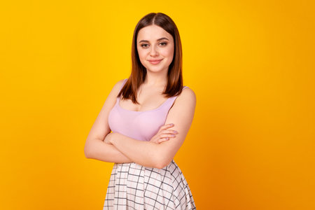 Profile side photo of young adorable woman confident crossed hands isolated over yellow color...
