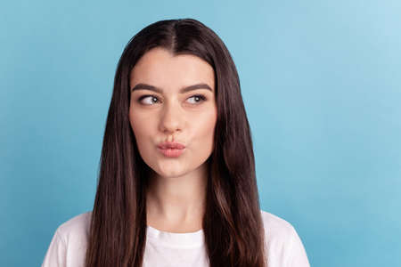 Photo of youth attractive lady pouted lips send air kiss look empty space isolated over blue color backgroundの写真素材