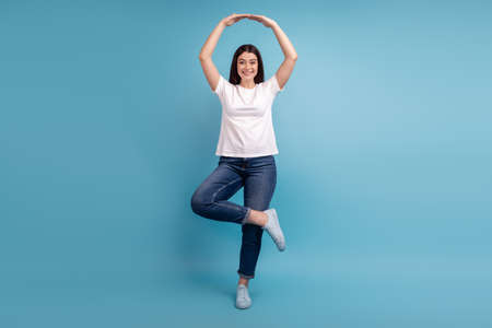 Full length photo of young attractive woman elegance ballerina dance isolated over blue color backgroundの写真素材