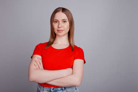Photo of young lovely woman folded hands confident wear casual clothes isolated over grey color backgroundの写真素材
