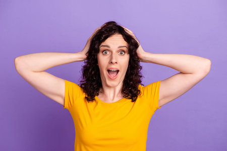Photo of young woman arms touch head amazed shocked fake news stupor isolated over violet color...
