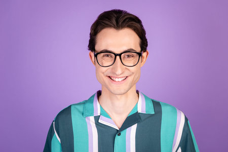 Photo of young cheerful man good mood confident clever toothy smile marketer isolated over violet color backgroundの写真素材
