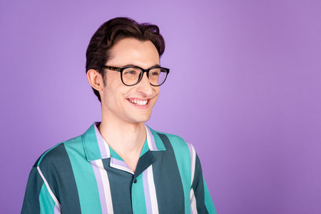 Profile side photo of young cheerful man good mood confident leader look empty space isolated over violet color backgroundの写真素材