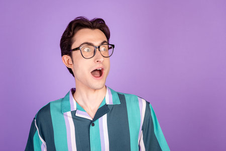 Profile side photo of young man astonished crazy look empty space fake news isolated over violet...