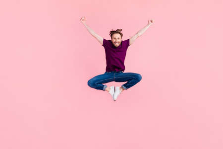 Full size photo of young excited man jump carefree travel trip dream wear casual clothes isolated over pink color backgroundの写真素材