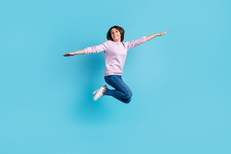Full size profile side photo of young pretty woman have fun carefree hands wings fly isolated over...