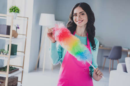 Photo of young pretty woman good mood hold colorful duster cleaning service housemaid spring-clean indoorsの写真素材