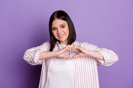 Photo of young lovely girl show fingers heart shape cupid romantic date isolated over violet color...