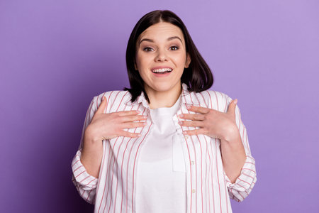 Photo of young pretty girl hands touch chest amazed shock unexpected questioned isolated over violet...