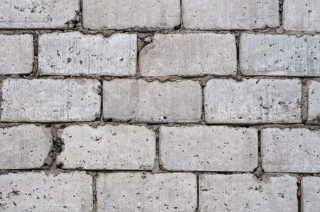 gray wall of large concrete blocks, background, texture, uneven masonry