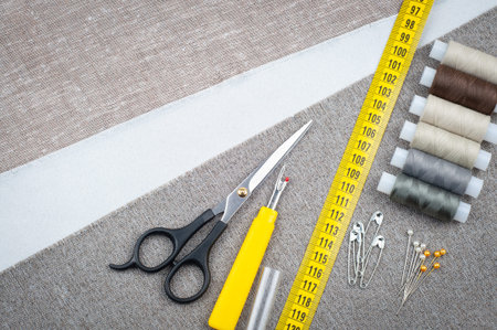 sewing pattern, composition with scissors, spools of thread, pins, measuring tape, Seam ripper,...