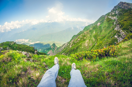 beautiful first-person view from a high mountain, with legs in the frame, fisheye distortionの写真素材