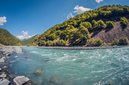 landscape beautiful stormy turquoise mountain river summer sunny dayの写真素材