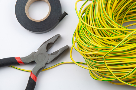 pliers electrical tape and bundle of wires on a white background close-upの写真素材