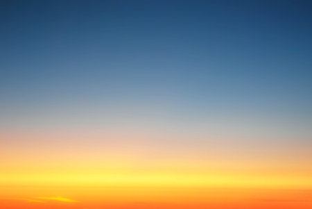 background, clear sky above the clouds, at sunset, view from the window of an airplane