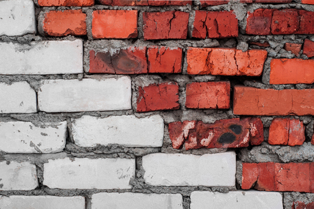 Red and white old worn brick wall with concrete, bricks texture background.の写真素材