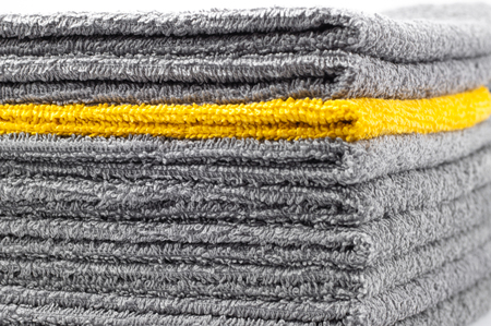 stack of gray and yellow terry towels, conceptual background, close-upの写真素材