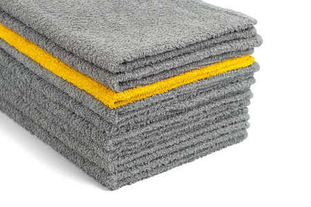 stack of gray and yellow terry towels, close-up, isolateの写真素材
