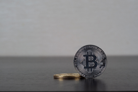 Bitcoin gold and silver coin on the black table white background close-up, copy spaceの写真素材