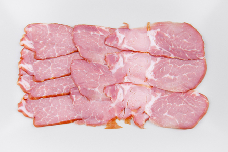 meat sliced in a rectangular plate on a dark background close-upの写真素材