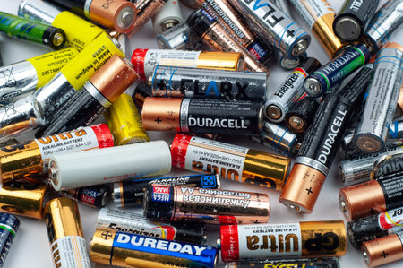 used various batteries lie in a heap, environmental problems and pollution of the soil and the...