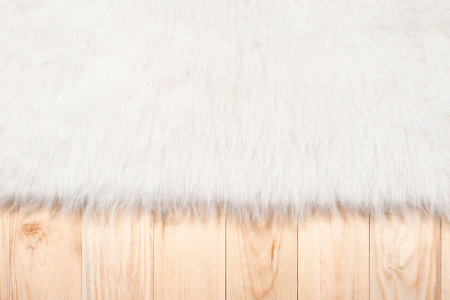 Faux fur background on light wooden natural floor. close-up, top view, copy spaceの写真素材