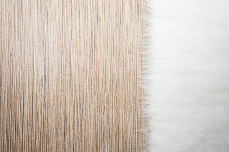 fur carpet background on light wooden natural floor. close-up, top view, copy spaceの写真素材