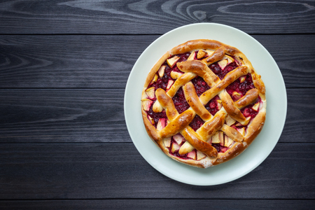 fruit cake in a plate on a dark wooden background. top viewの写真素材