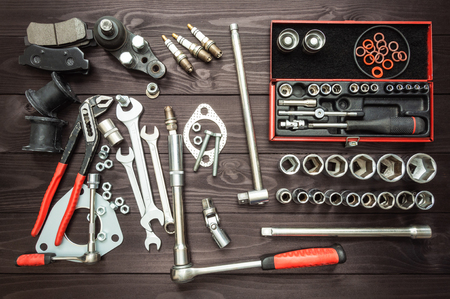 tools and car parts on a dark wooden workbenchの写真素材