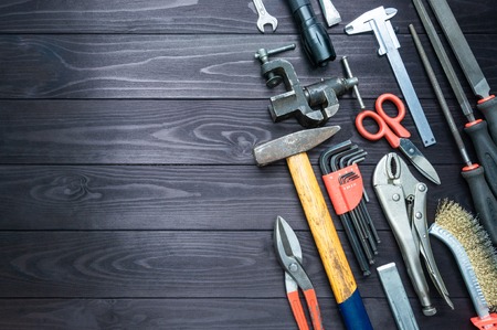 Background from various tools on a dark wooden workbench. top view. copy spaceの写真素材