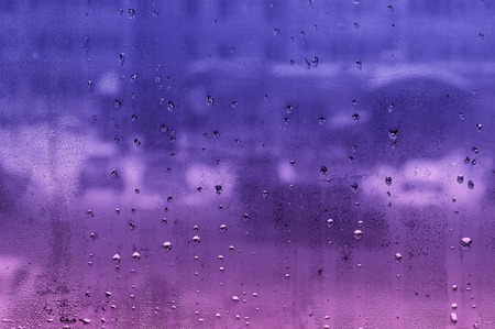 water droplets on glass with blurred boke in the backgroundの写真素材