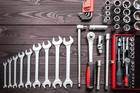 the set of auto tools on a dark wooden workbench. copy space