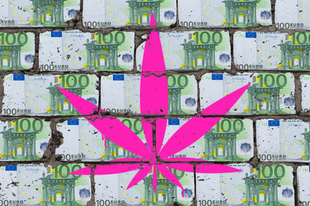 Painted cannabis leaf on the wall of euro. Marijuana business art concept.の写真素材