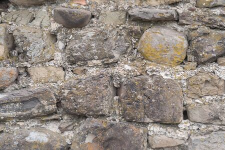 the natural texture background of an old wall. old medieval masonryの写真素材