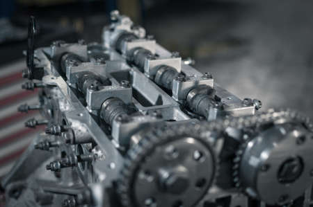 cylinder head on a disassembled engine in a car workshopの写真素材