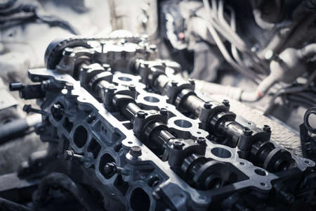 cylinder head on a disassembled engine in a car workshopの写真素材