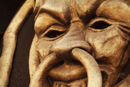 a golden mask-like face photographed on one of London's facadesのeditorial素材