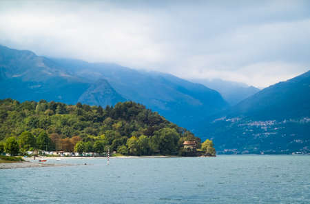 a view of a forest and the Italian Alps from Colico, a town at Lake Comoの写真素材