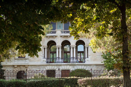 photo of a traditional European facade hiding behind trees in Bergamo, Italyの写真素材