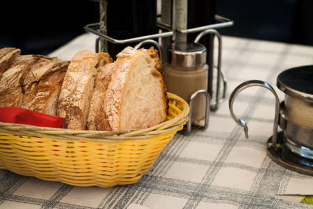 yellow basket full of bread photographed in a small Italian restaurantの写真素材