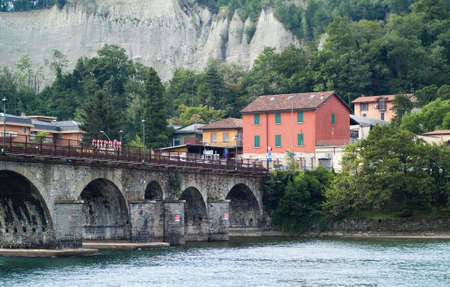 Lecco, Italy - September 2nd, 2015: photo of a bridge over the River Adda in Lecco, Italy, with colorful houses in the background.のeditorial素材