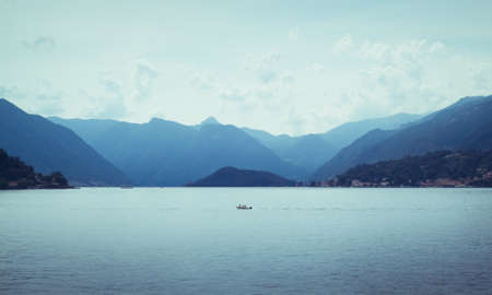 beautiful view of mountains disappearing into the distance at Lake Como in Italyの写真素材