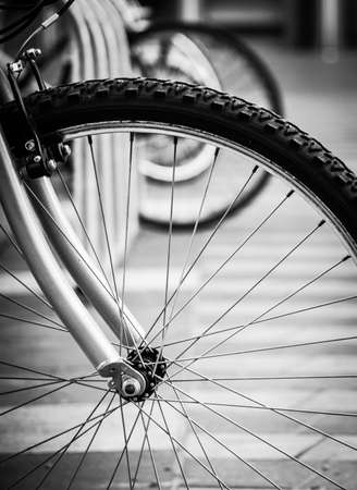 a black-and-white closeup photo of a bicycle parked in central Londonの写真素材