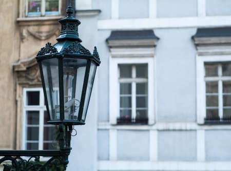 closeup photo of a streetlamp, with traditionally Czech  facades in the backgroundの写真素材